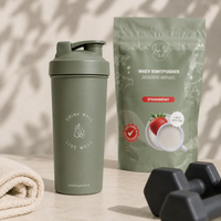 Lisa Kookt shakebeker naast de zak whey eiwitpoeder aardbei, klaar voor na het sporten